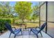 Outdoor patio features a lake view, outdoor seating, and privacy screen at 258 Rustic Loop, Sanford, FL 32771