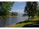 Scenic pond with a fountain surrounded by lush greenery and trees, enhancing the community's appeal at 258 Rustic Loop, Sanford, FL 32771