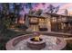Inviting backyard featuring a fire pit and an elevated deck with string lights and hot tub at 2628 Spruce Creek Blvd, Port Orange, FL 32128