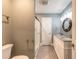 Well-lit bathroom featuring double sink vanity with granite counters and a tiled glass shower at 2628 Spruce Creek Blvd, Port Orange, FL 32128