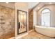 Bathroom featuring soaking tub, walk-in shower, and large vanity mirror at 2628 Spruce Creek Blvd, Port Orange, FL 32128