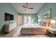Bright bedroom with pastel walls, ceiling fan, and door leading to outdoor balcony at 2628 Spruce Creek Blvd, Port Orange, FL 32128