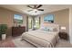 Bedroom featuring neutral colors, ceiling fan, and matching furniture at 2628 Spruce Creek Blvd, Port Orange, FL 32128
