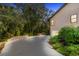 Home exterior with large driveway and some landscaping at 2628 Spruce Creek Blvd, Port Orange, FL 32128