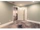Hallway with painted walls, white trim, and stained concrete flooring at 2628 Spruce Creek Blvd, Port Orange, FL 32128