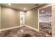 Hallway featuring neutral paint, white trim and stained concrete flooring at 2628 Spruce Creek Blvd, Port Orange, FL 32128