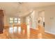 Spacious, sun-filled room with hardwood floors, seamlessly connecting living spaces at 2628 Spruce Creek Blvd, Port Orange, FL 32128