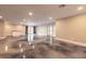 Large, open living room with stained concrete floors and doors to the backyard at 2628 Spruce Creek Blvd, Port Orange, FL 32128