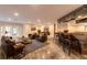 Spacious living room with a bar, leather furniture, and ample natural light at 2628 Spruce Creek Blvd, Port Orange, FL 32128