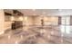 Vast recreation space with a bar and stained concrete floors, perfect for entertaining at 2628 Spruce Creek Blvd, Port Orange, FL 32128