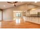 Open-concept living area featuring hardwood floors, vaulted ceiling, and modern kitchen at 2628 Spruce Creek Blvd, Port Orange, FL 32128