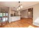 Spacious open concept with hardwood floors, modern lighting, and a breakfast bar at 2628 Spruce Creek Blvd, Port Orange, FL 32128