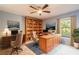 Office featuring blue walls, a ceiling fan, and two large desks at 2628 Spruce Creek Blvd, Port Orange, FL 32128