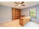Office featuring blue walls, a ceiling fan, and large desk at 2628 Spruce Creek Blvd, Port Orange, FL 32128