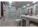 Bathroom featuring a shower, vanity with storage, and modern fixtures at 2800 N Atlantic Ave # 1715, Daytona Beach, FL 32118