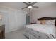 Bedroom featuring a flamingo themed comforter, ceiling fan, and large closet at 2800 N Atlantic Ave # 1715, Daytona Beach, FL 32118