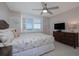 Bedroom featuring a ceiling fan, water views, and wood paneling at 2800 N Atlantic Ave # 1715, Daytona Beach, FL 32118