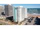 Exterior shot of The Towers Condominiums showcasing the surrounding parking and nearby beach at 2800 N Atlantic Ave # 1715, Daytona Beach, FL 32118