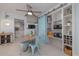 Bright dining area with blue chairs, table, a ceiling fan, and a pantry with sliding barn doors at 2800 N Atlantic Ave # 1715, Daytona Beach, FL 32118