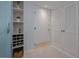 Hallway featuring built-in wine racks, storage, and tiled floors at 2800 N Atlantic Ave # 1715, Daytona Beach, FL 32118