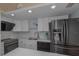Well-lit kitchen features stainless steel appliances, white cabinets and countertops, and modern fixtures at 2800 N Atlantic Ave # 1715, Daytona Beach, FL 32118