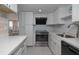 Bright kitchen with white cabinetry, modern appliances, and adjacent living space at 2800 N Atlantic Ave # 1715, Daytona Beach, FL 32118
