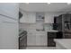 Charming kitchen featuring white cabinets, subway tile backsplash, and stainless steel appliances at 2800 N Atlantic Ave # 1715, Daytona Beach, FL 32118