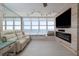 Cozy living room featuring an electric fireplace, a large window showcasing ocean views, and comfortable seating at 2800 N Atlantic Ave # 1715, Daytona Beach, FL 32118