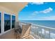 This balcony has ocean views, glass doors to the interior and seating at 2937 S Atlantic Ave # 1907, Daytona Beach Shores, FL 32118