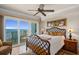 Bedroom showcasing water views, patio access, warm lighting, and elegant decor at 2937 S Atlantic Ave # 1907, Daytona Beach Shores, FL 32118