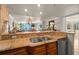 Granite countertops, stainless steel sink, and a view of the living area through the kitchen pass-through at 2937 S Atlantic Ave # 1907, Daytona Beach Shores, FL 32118