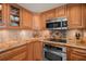 Close-up of the kitchen with granite counters, stainless appliances, and tile backsplash at 2937 S Atlantic Ave # 1907, Daytona Beach Shores, FL 32118