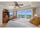 Bright main bedroom features a ceiling fan, ocean views, sliding glass doors leading to a balcony, and neutral decor at 2937 S Atlantic Ave # 1907, Daytona Beach Shores, FL 32118
