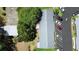 Overhead view of building with parking spaces and mature trees surrounding it at 3 Fairway Ct, Deland, FL 32724