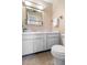 Bathroom with unique seashell wallpaper, vanity, and toilet at 3 Fairway Ct, Deland, FL 32724