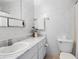 Neat bathroom featuring a clean white vanity and patterned wallpaper at 3 Fairway Ct, Deland, FL 32724