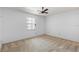 Bright bedroom features a ceiling fan and a window letting in natural light at 3 Fairway Ct, Deland, FL 32724