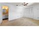 Bedroom features a closet, ceiling fan, and an adjoining bathroom at 3 Fairway Ct, Deland, FL 32724