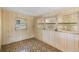 Bright sunroom offers tile floors, wood paneling, and ample natural light at 3 Fairway Ct, Deland, FL 32724