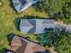 Overhead view of well-maintained residential property with a gray roof, surrounded by trees and neighboring homes at 307 Stonington Way, Deland, FL 32724