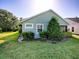 Charming home featuring a well-maintained lawn and landscaped garden beds with mature shrubs and decorative trees at 307 Stonington Way, Deland, FL 32724