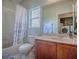 Bright bathroom with a shower-tub combo, a window for natural light, and a vanity for storage at 307 Stonington Way, Deland, FL 32724