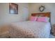 Comfortable bedroom featuring a floral-patterned bedspread, a decorative wreath and light and bright walls at 307 Stonington Way, Deland, FL 32724