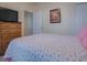 Inviting bedroom featuring a traditional chest of drawers with TV on top and a double closet at 307 Stonington Way, Deland, FL 32724