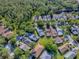 Aerial shot of a lovely residential neighborhood with tree-lined streets and well-maintained homes surrounded by lush greenery at 307 Stonington Way, Deland, FL 32724