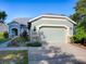 Daytime view of a charming single-Gathering home with a two-car garage at 307 Stonington Way, Deland, FL 32724