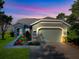 Charming single-Gathering home with a well-manicured lawn and colorful flower beds at 307 Stonington Way, Deland, FL 32724