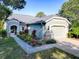 Charming home featuring manicured flower beds and inviting curb appeal with a well-maintained front yard and attached garage at 307 Stonington Way, Deland, FL 32724