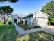 Beautiful one-story home featuring lush landscaping, a two-car garage, and a welcoming entrance at 307 Stonington Way, Deland, FL 32724