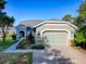 Beautiful single-Gathering home with a two-car garage, manicured landscaping, and a welcoming walkway to the front door at 307 Stonington Way, Deland, FL 32724